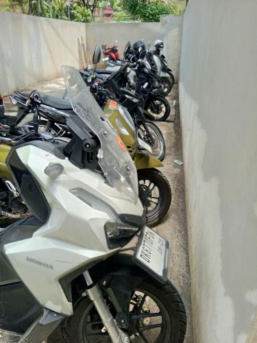 a row of motorcycles parked next to a wall at Wanderlust Hostel Mandalika in Kuta Lombok