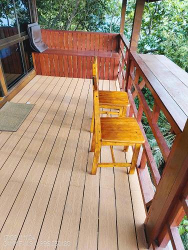 a wooden bench sitting on a wooden deck at Tao Thong Villa 2 in Ko Tao