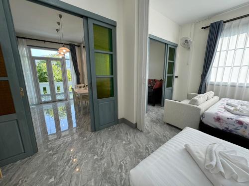 a room with a bed and a room with a door at Garden House Rice Field and Mountain View in Luang Prabang