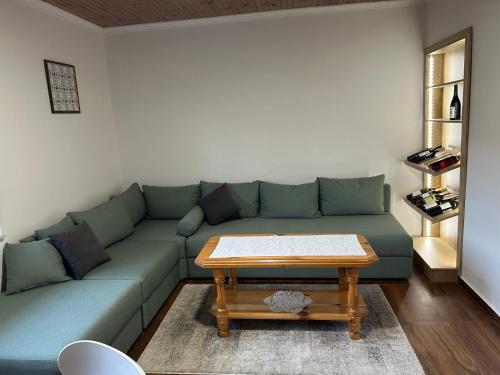 a living room with a green couch and a coffee table at Villa Goranci in Mostar
