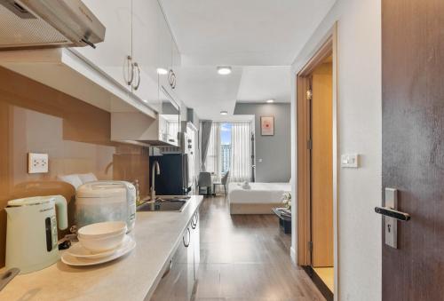 a kitchen with a counter with dishes on it at Căn hộ Rivergate - Sài Gòn, Quận 4 in Ho Chi Minh City