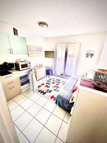 - une petite cuisine avec un lit dans une chambre dans l'établissement Petit Cocon près de la grande plage, à Saint-Hilaire-de-Riez
