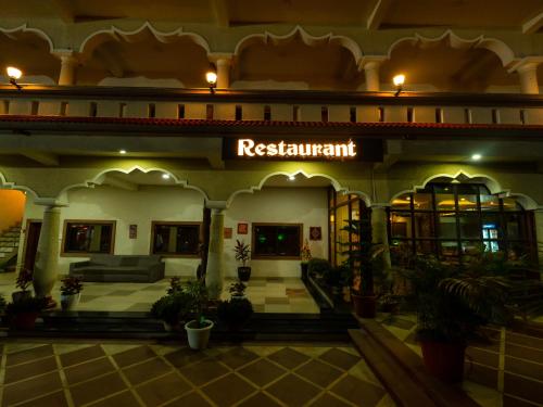 a building with a sign that reads restaurant at Hotel Royal Palace in Sāgar