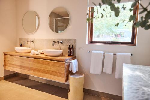 a bathroom with two sinks and a mirror at Yarradene Luxury Healesville Farmstay in Healesville
