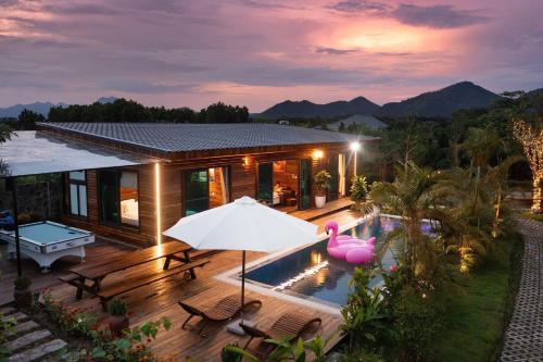 a house with a swimming pool and a pink flamingo at Mimi's House Sóc Sơn - Venuestay in Ấp Ðông Ðô
