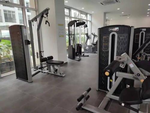 a gym with several treadmills and cardio machines at Amani Staycation Bandar Seri Alam#Studio in Masai