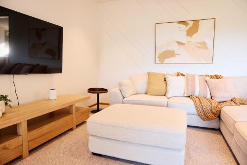 a living room with a couch and a table at Yarradene Luxury Healesville Farmstay in Healesville
