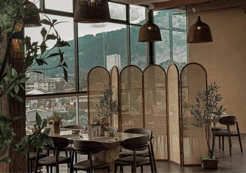a restaurant with a table and chairs and a large window at Kingston Hotel 13 - Penang Hills formerly known as Deview Hotel in Ayer Itam