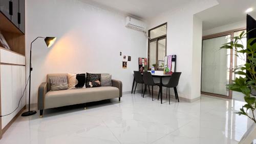 a living room with a couch and a table at House of Great White Apartment in Shenzhen