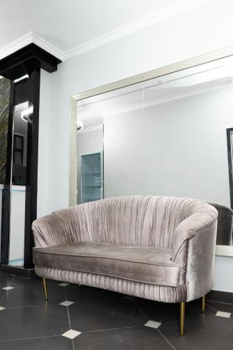 a leather couch in a room with a mirror at The Rest Hostel in Astana