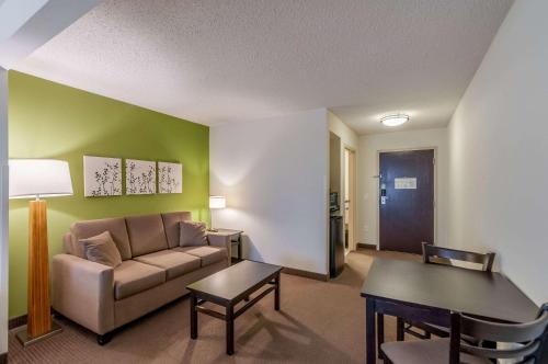 a living room with a couch and a table at Sleep Inn & Suites Harrisonburg near University in Harrisonburg