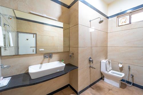 a bathroom with a sink and a toilet at Hotel Royal Palace in Sāgar