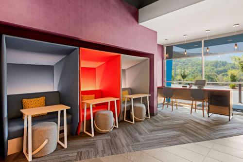 a waiting room with tables and chairs and a desk at Tru by Hilton Asheville Blue Ridge Parkway in Asheville