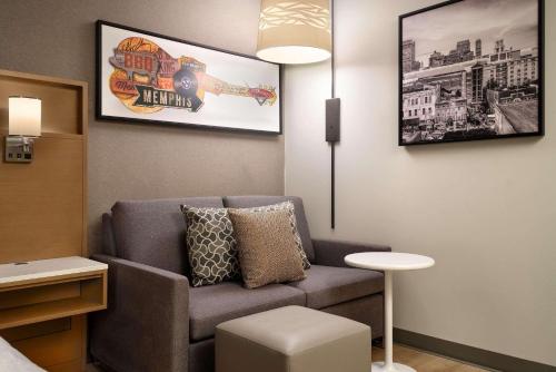 a living room with a couch and a table at Radisson Hotel West Memphis in West Memphis