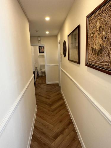 a hallway with a stairway with a picture on the wall at Royal Pavilion Garden Apartment with Parking in Brighton & Hove