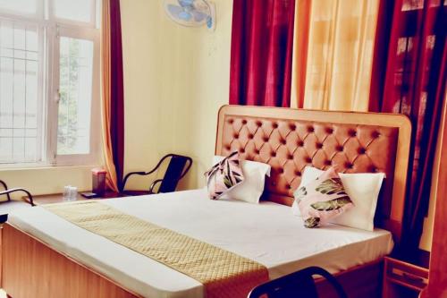 a bed with two pillows on it in a room at The Boho near Mall in Shimla