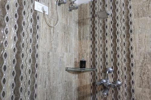 a shower with a shower head in a bathroom at Hotel Dior Near Jal Mahal, Jaipur in Jaipur