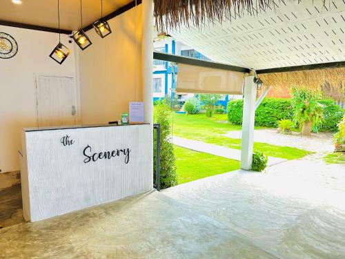 a reception area at a resort with a sign that reads the sanctuary at The Scenery Beach Resort in Baan Khai