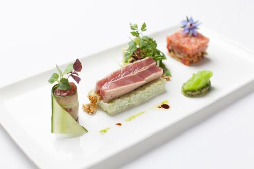 a plate of food with meat and vegetables on it at Storchen Restaurant Hotel in Bad Krozingen