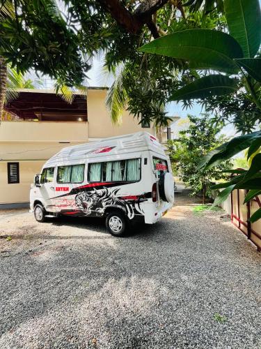 a white van parked in front of a house at Chaithanya Residency Near to NIT in Kunnamangalam
