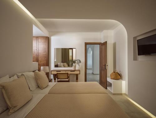 a bedroom with a bed and a living room at Thesan Villas in Marathias