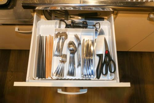 a tray filled with utensils sitting on a table at Souwaan in Takayama