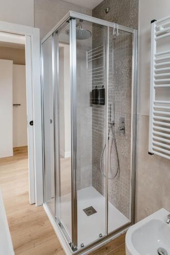 a glass shower in a bathroom with a sink at Residence Piccolo Olimpo in Toscolano Maderno