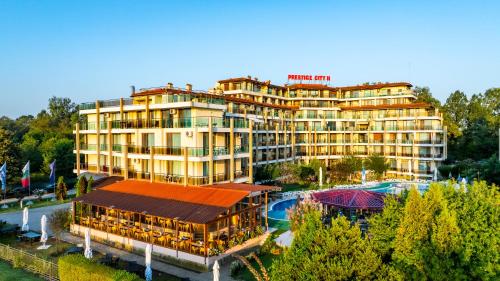a hotel building with a pool in front of it at Aparthotel Hotel Prestige City II in Primorsko