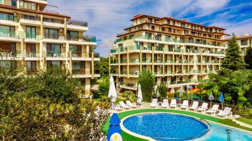 a hotel with a swimming pool and two buildings at Aparthotel Hotel Prestige City II in Primorsko