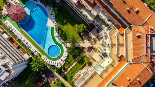 an overhead view of a swimming pool next to a building at Aparthotel Hotel Prestige City II in Primorsko