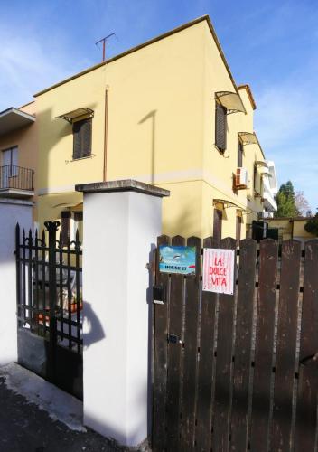 a house with a sign on a fence at HOUSE 27 in Fiumicino
