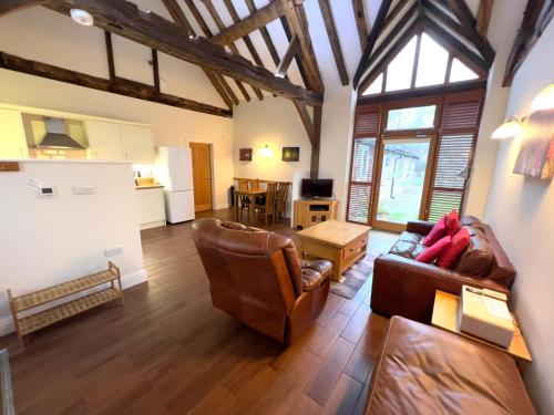 a living room with a couch and a table at 2 Moatside Cottages in Hassocks