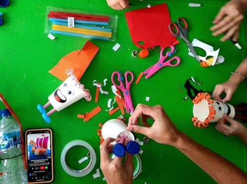 a group of people making crafts on a table at The Gaia Hotel Bandung in Bandung