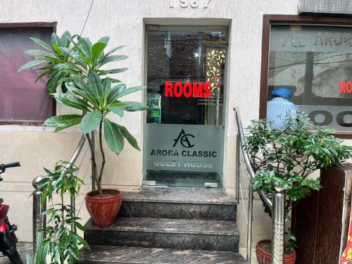 a front door of araxaea classic guest house with plants at Arora classic guest house in Amritsar