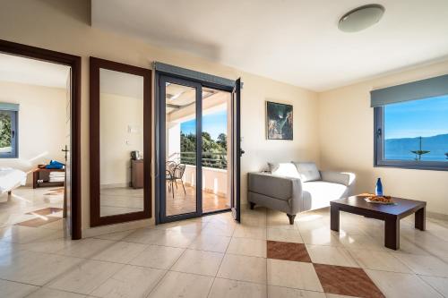a living room with a couch and a table at Porto Galini Seaside Resort & Spa in Nikiana