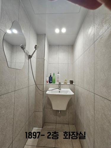 a bathroom with a sink and a shower at Yachtie Inn 1897 in Mokpo