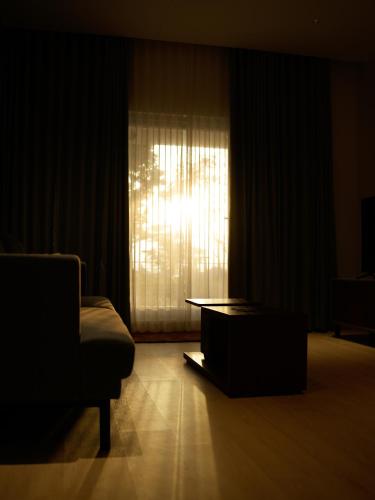 a living room with a couch and a window at Ocean Whisper- psst! hidden gem in Kaipamangalam