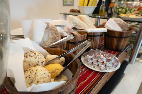 a buffet with baskets of bread and other food at Ramada Hotel, Suites and Apartments by Wyndham Dubai JBR in Dubai