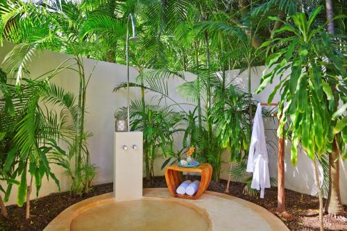 a room with a table and some plants at Viceroy Riviera Maya, a Luxury Villa Resort - Adults Only in Playa del Carmen