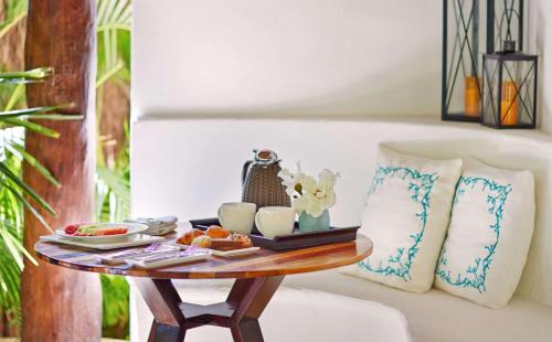 a table with a tray of breakfast food on it at Viceroy Riviera Maya, a Luxury Villa Resort - Adults Only in Playa del Carmen