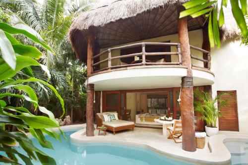 a villa with a bed and a swimming pool at Viceroy Riviera Maya, a Luxury Villa Resort - Adults Only in Playa del Carmen