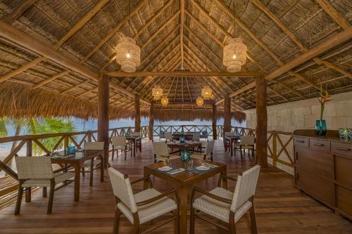 a restaurant with tables and chairs in a pavilion at Viceroy Riviera Maya, a Luxury Villa Resort - Adults Only in Playa del Carmen