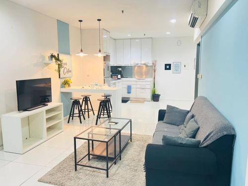 a living room with a couch and a table at Mercu Summer Suites Kuala Lumpur Bukit Bintang By Classy in Kuala Lumpur