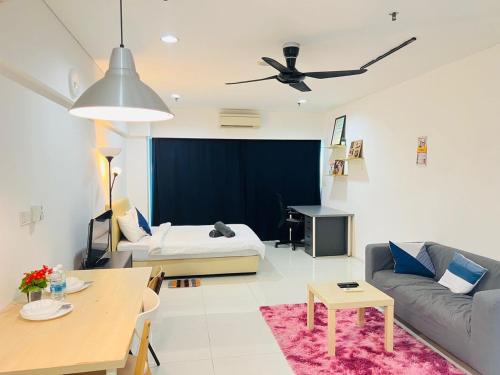 a living room with a couch and a table at Mercu Summer Suites Kuala Lumpur Bukit Bintang By Classy in Kuala Lumpur