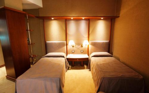 a room with two beds and a table in it at L'Isola Di Aurora in Martirano