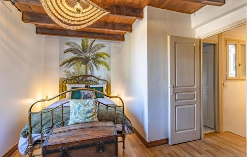 a bedroom with a wrought iron bed and a chandelier at 2 Bedroom Amazing Home In Monpazier in Monpazier