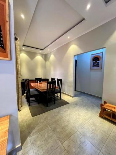 a dining room with a table and chairs at Moshi Epic Accommodation in Moshi
