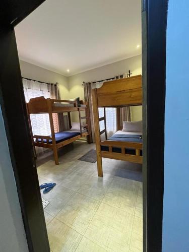 a room with three bunk beds in a room at Moshi Epic Accommodation in Moshi