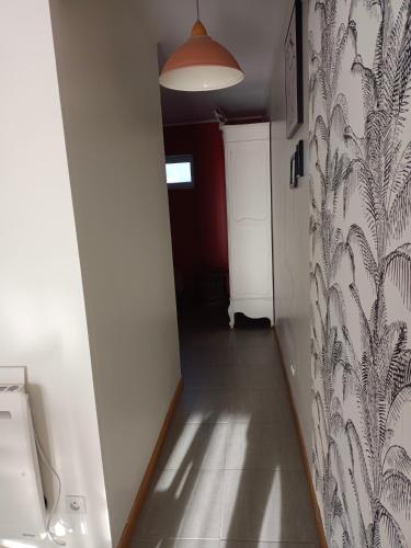 a hallway with a toilet in a room at Studio plein pied in Liévin