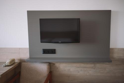 a flat screen tv mounted on a wall at ATLAS Hotel Tatry in Vysoké Tatry